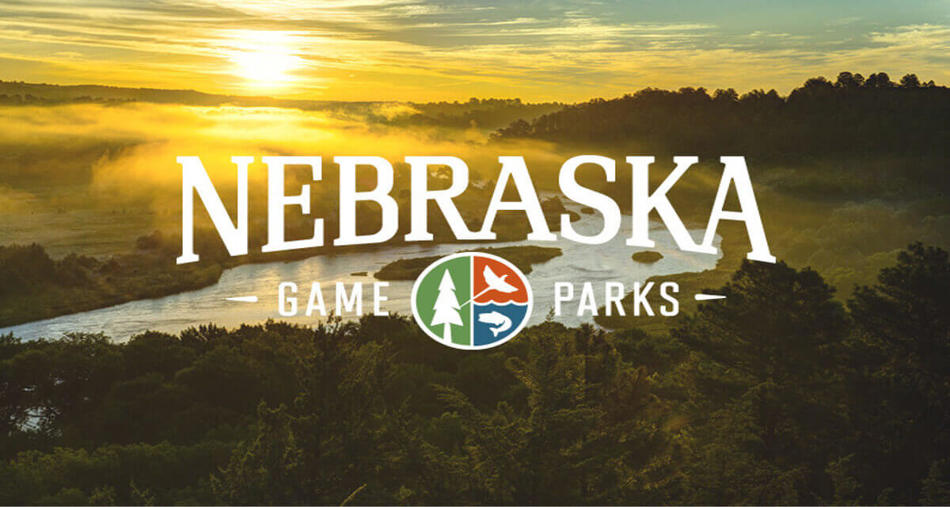 Nebraska Game and Parks Logo With a senery of a river and a sunrise in the background.